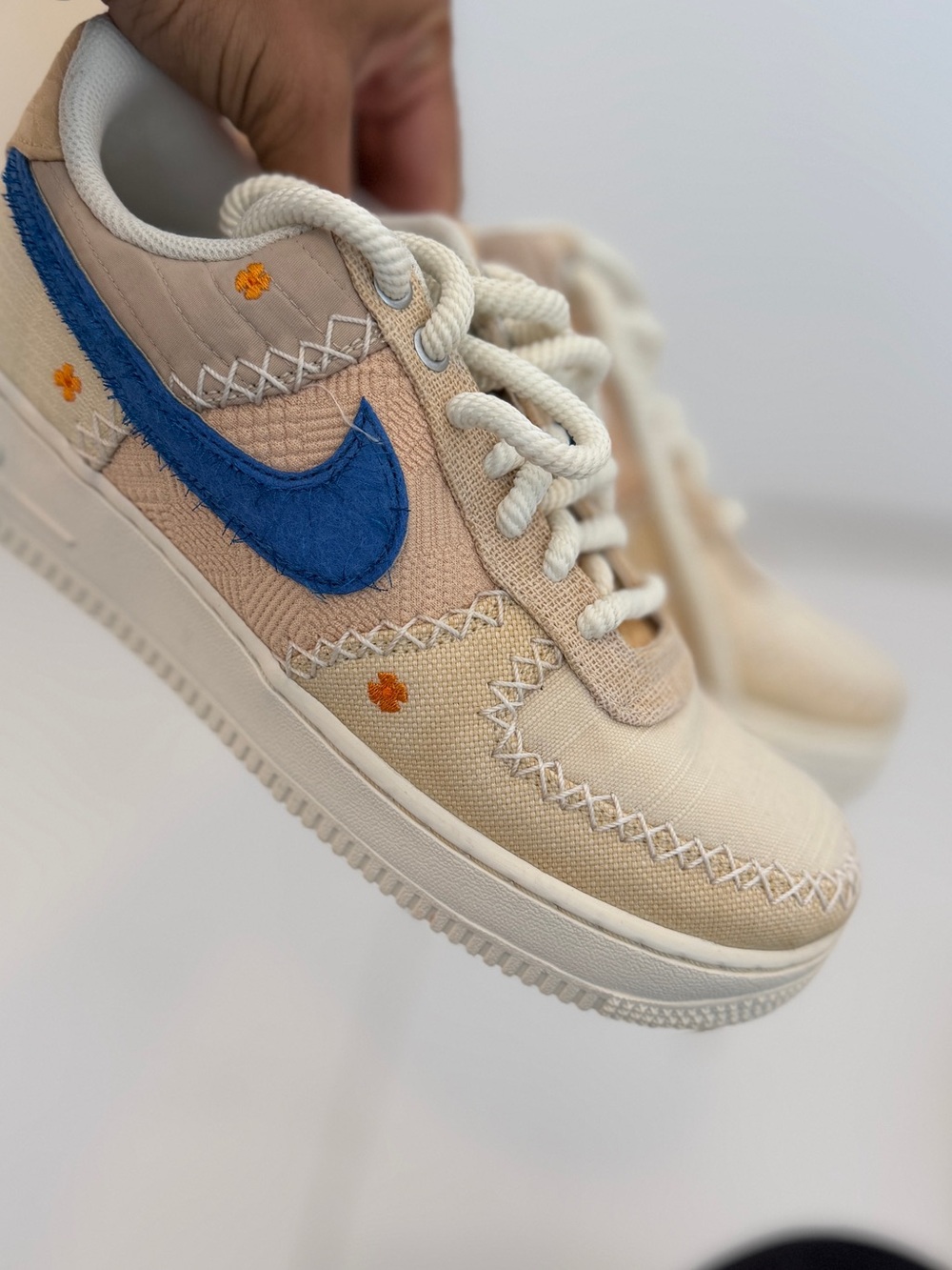 Nike women Cream Canvas Sneakers with Blue Swoosh and Orange Accents